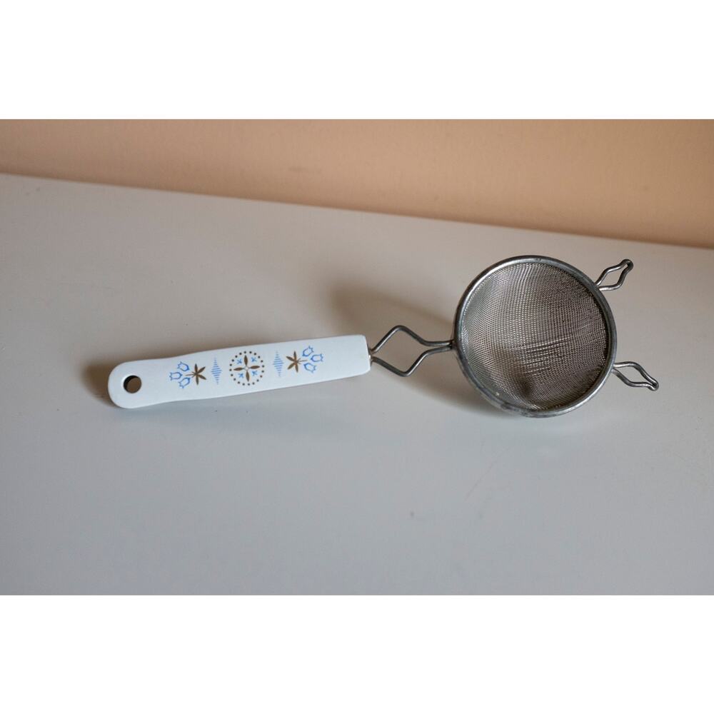 Cute vintage sifter with Scandinavian style designs on handle
